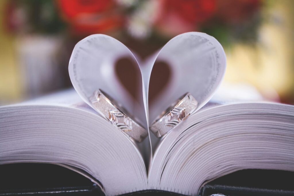 pexels-photo-288008-288008 Close-up of wedding rings on heart-shaped book pages symbolizing love and romance.
